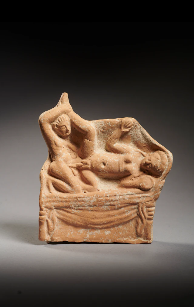 A Roman terracotta relief plaque with erotic scene
