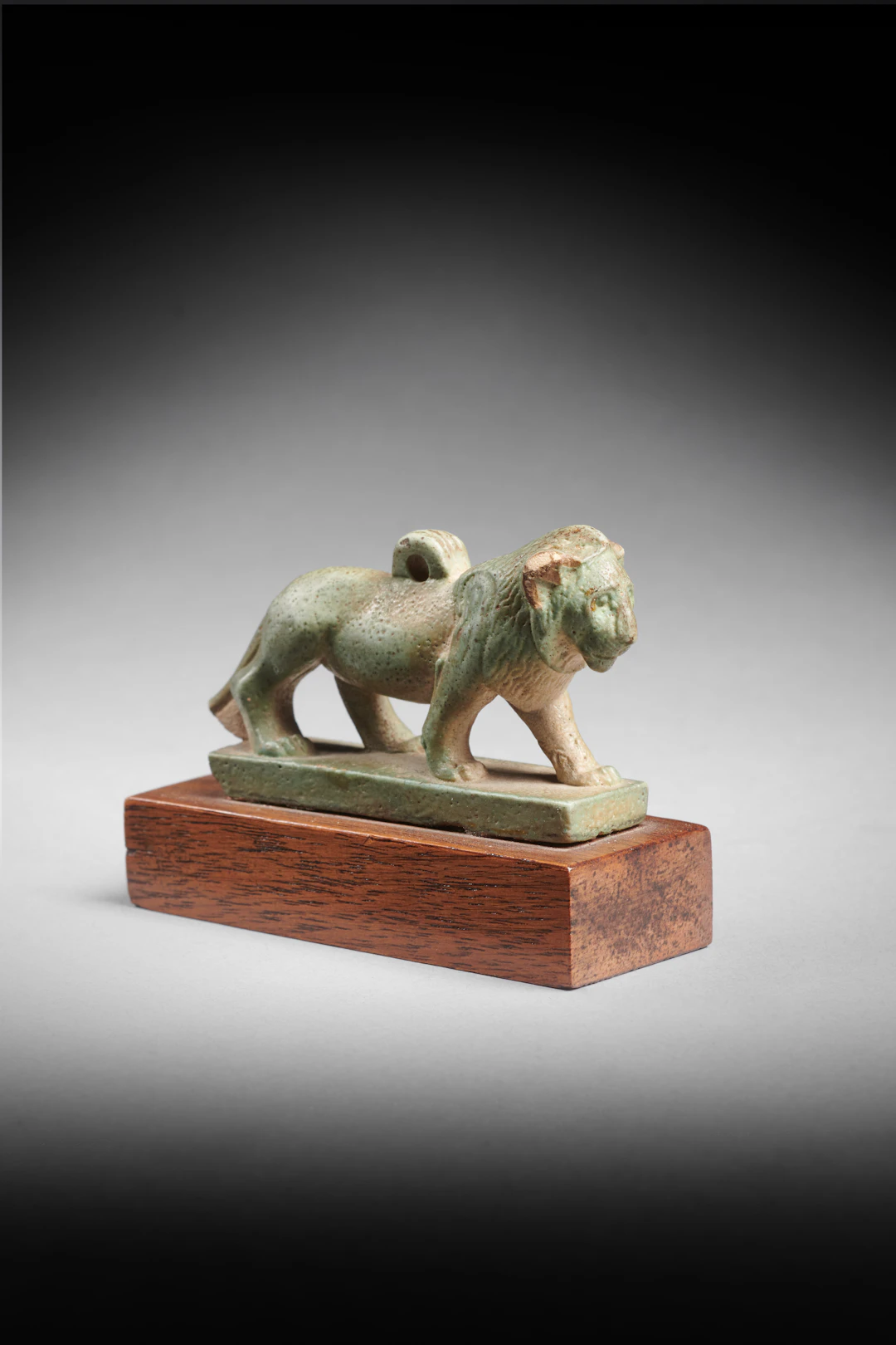 An Egyptian faience amulet of a lion