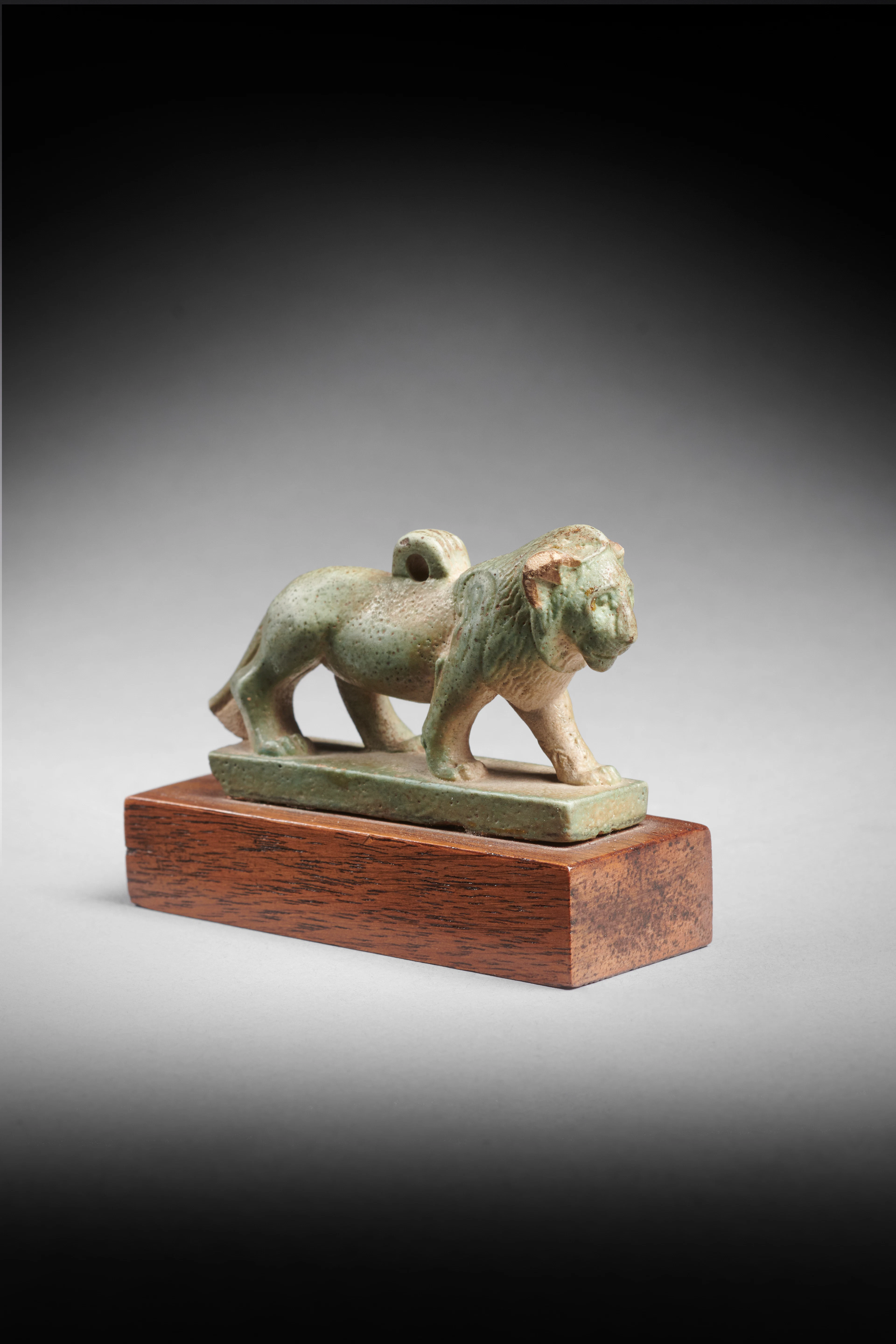An Egyptian faience amulet of a lion