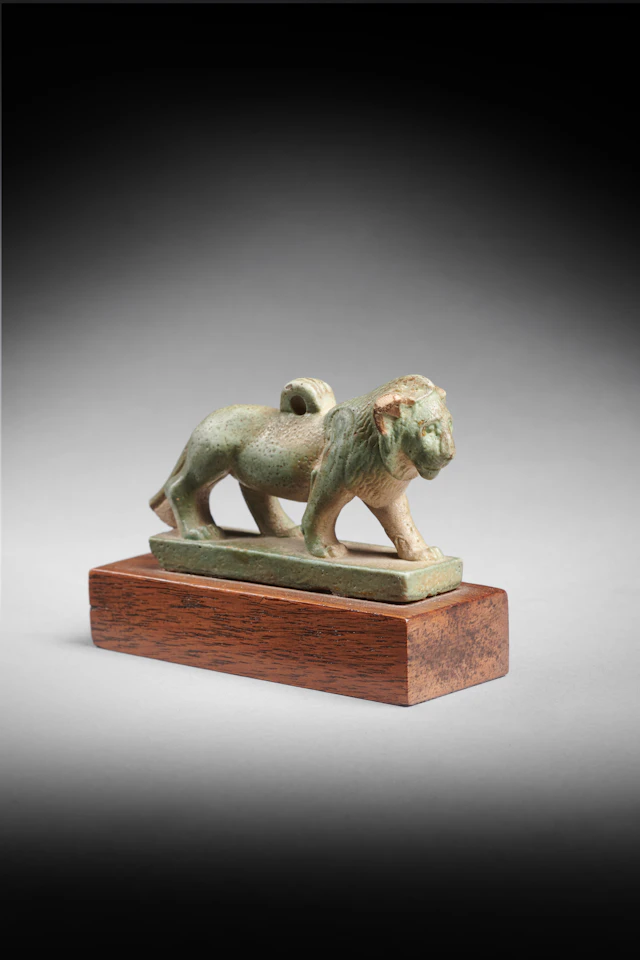 An Egyptian faience amulet of a lion