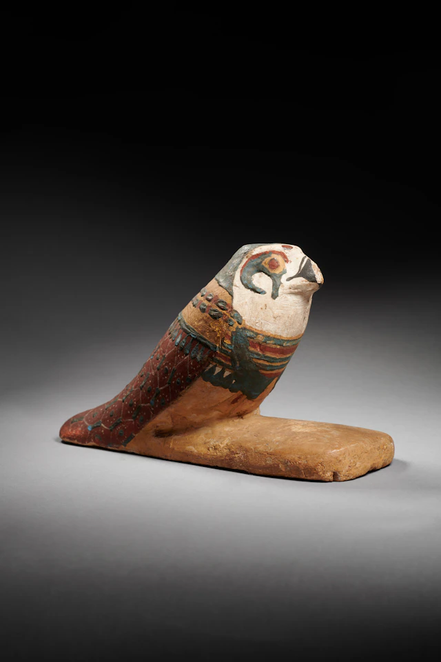 An Egyptian gesso-painted wood falcon