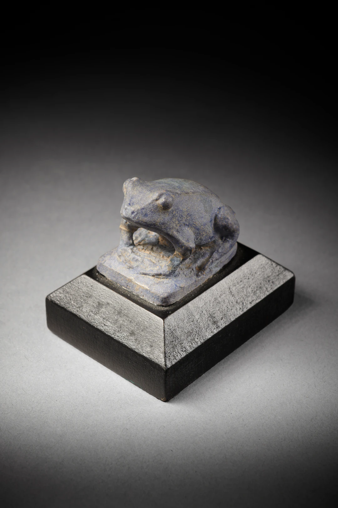 An Egyptian faience frog amulet representing the goddess Heqet