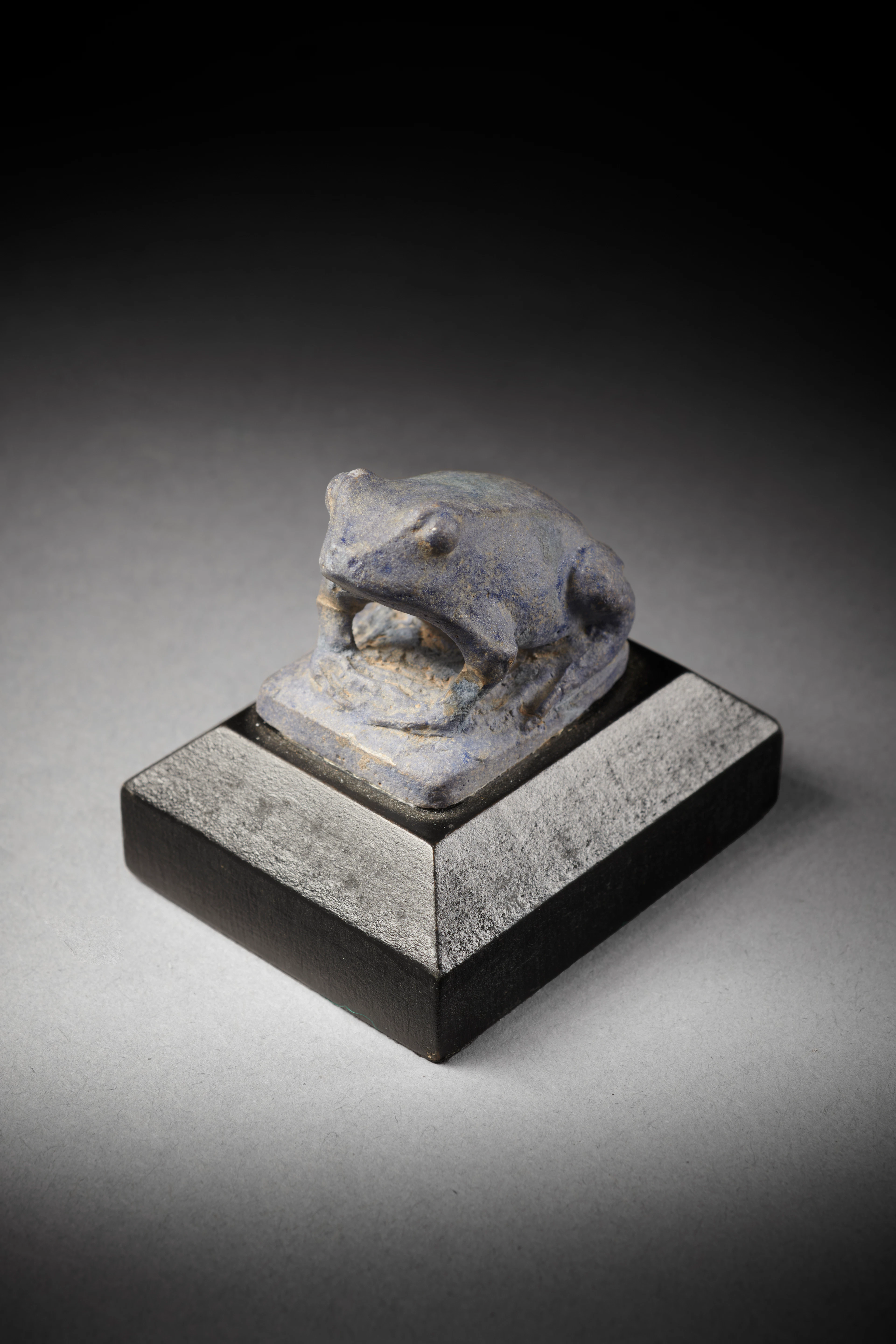 An Egyptian faience frog amulet representing the goddess Heqet
