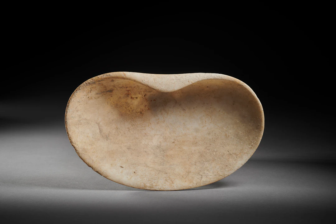 A Cycladic marble cup in the shape of a seashell