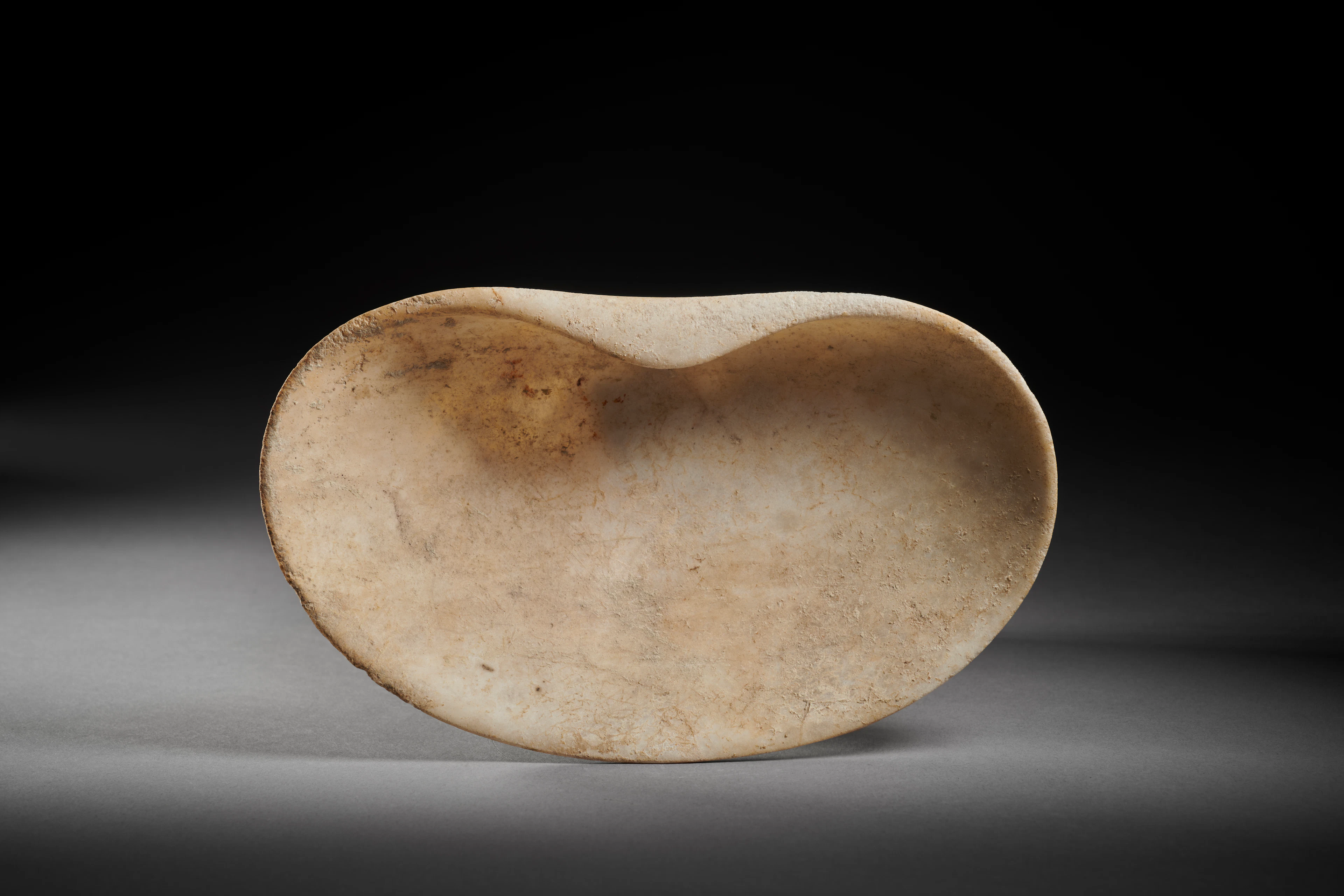 A Cycladic marble cup in the shape of a seashell
