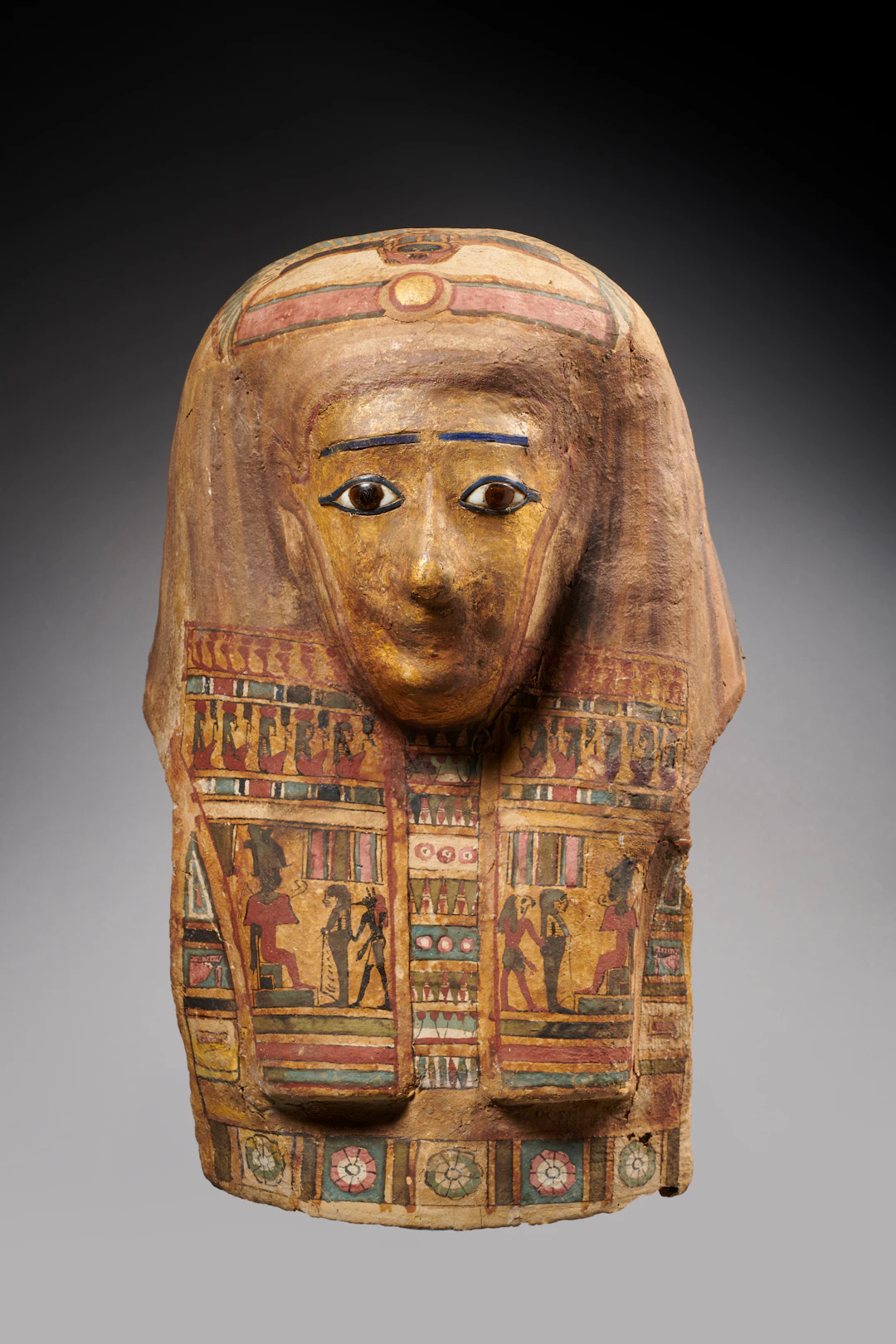 An Egyptian polychrome and gilt cartonnage mummy mask