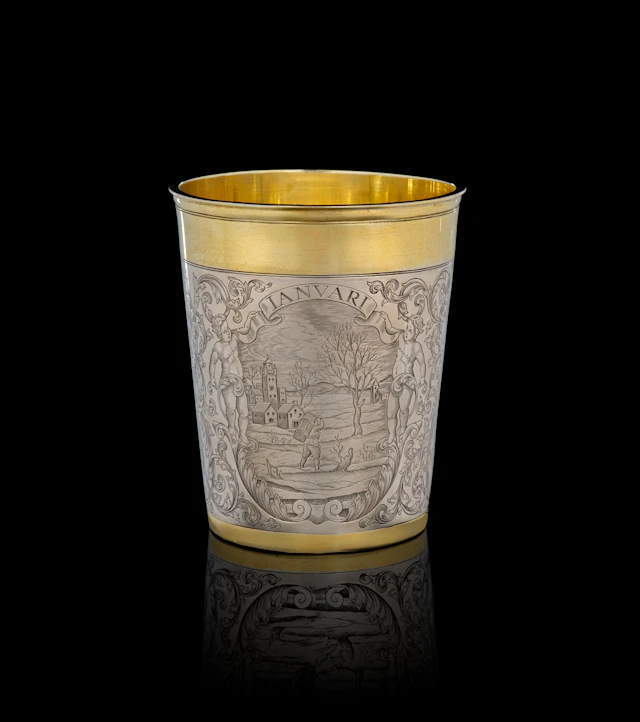 A German parcel-gilt silver "January" beaker, Simon Wickert, Augsburg