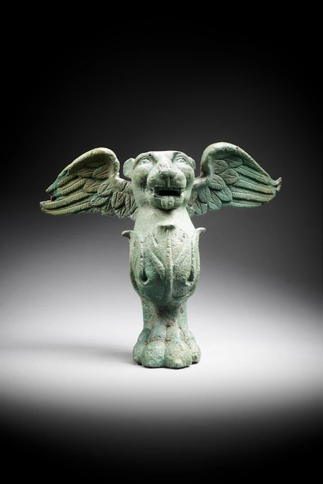 A Parthian bronze cista or furniture foot in the shape of a winged lion