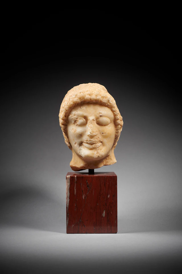 A Greek marble head of a Kouros