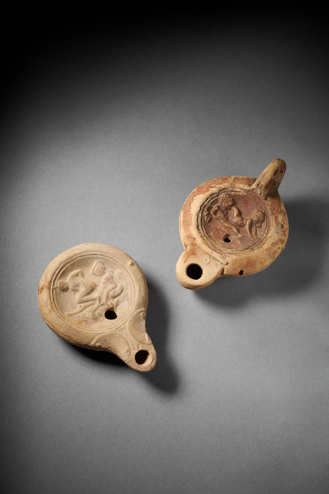 Two Roman terracotta oil lamps with Erotic scene