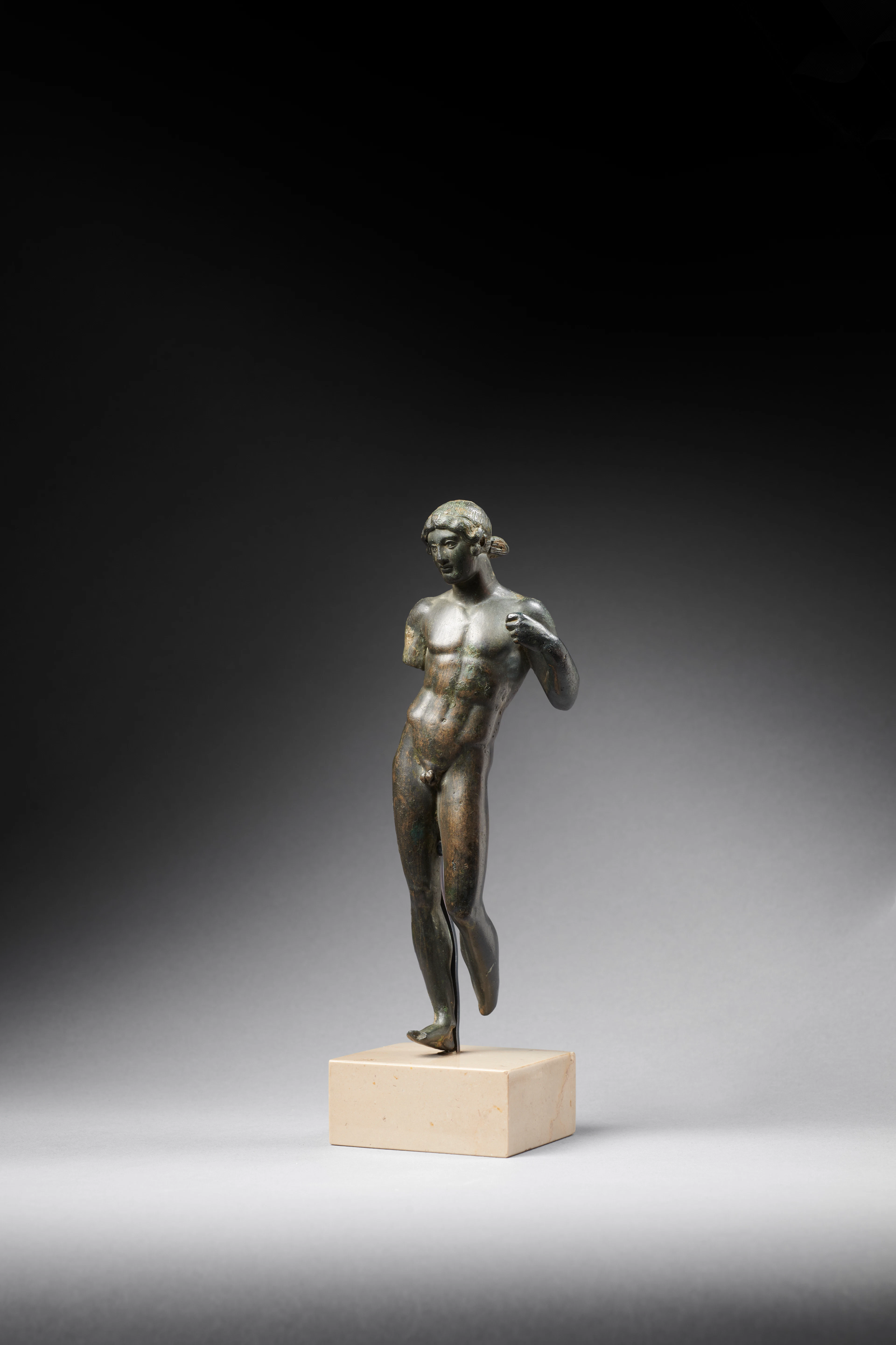A Roman bronze statuette of a young man, probably the god Apollo