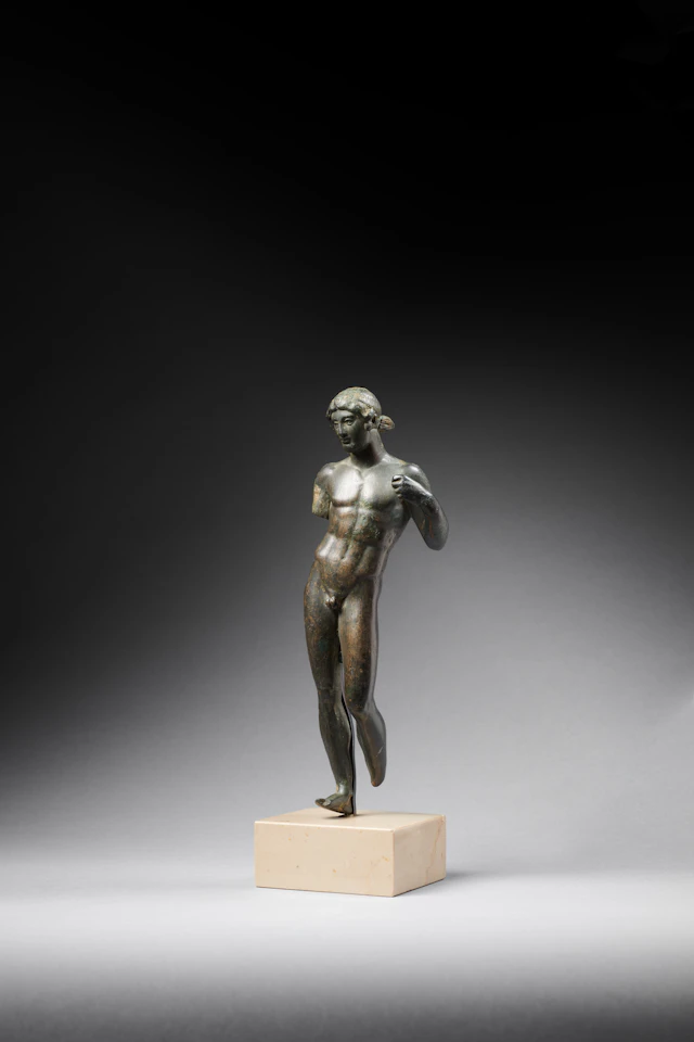 A Roman bronze statuette of a young man, probably the god Apollo