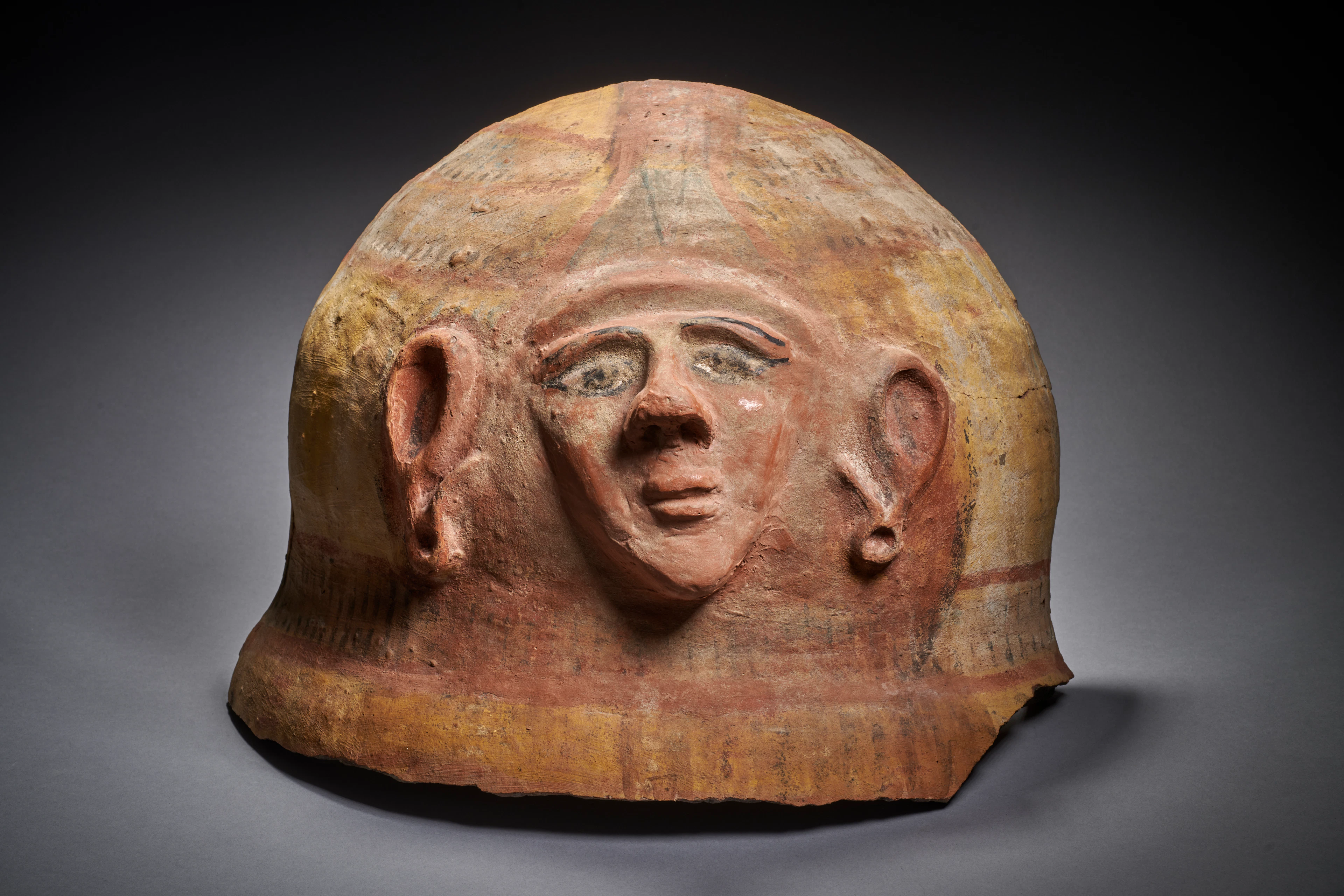 An Egyptian painted terracotta sarcophagus mask