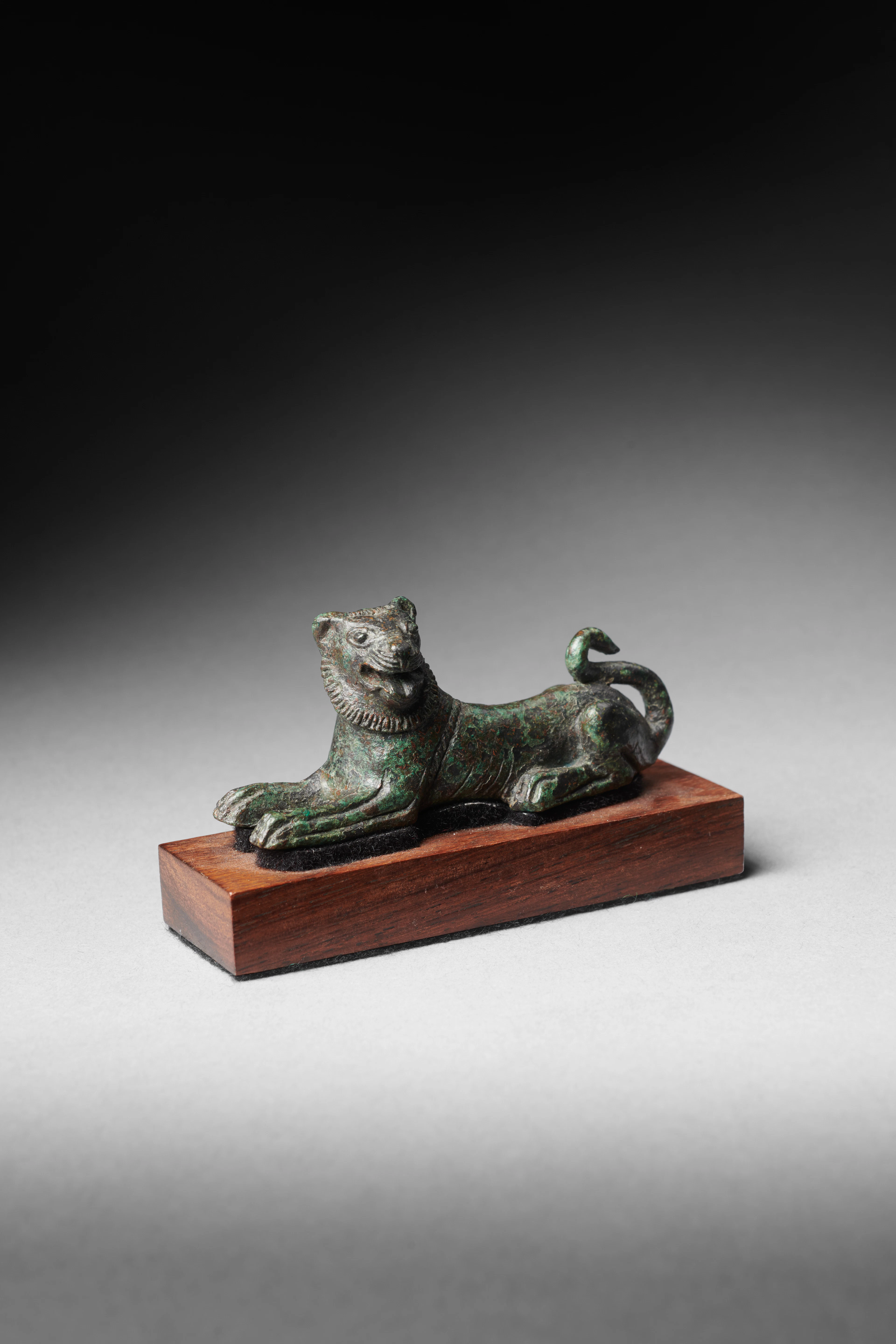 An Etruscan bronze figure of a recumbent lion