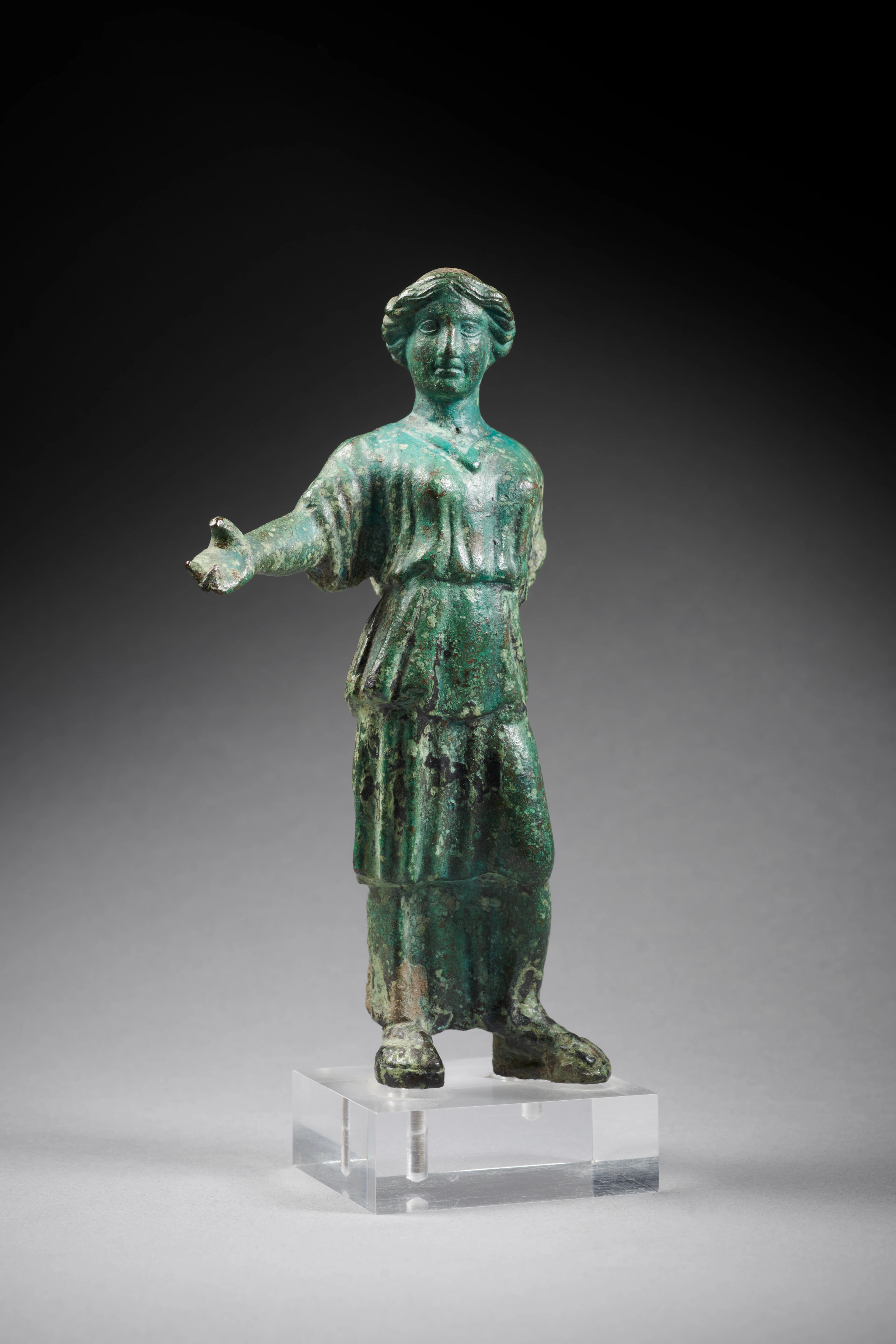 A Roman bronze statuette of a woman