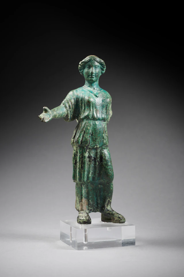 A Roman bronze statuette of a woman