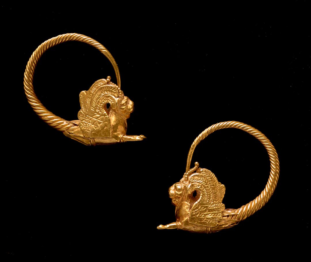 A Hellenistic pair of gold earrings with winged lions