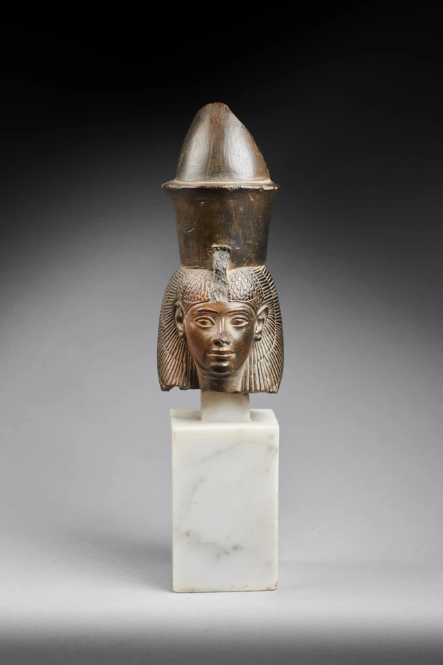 An Egyptian greywacke head of the goddess Mut