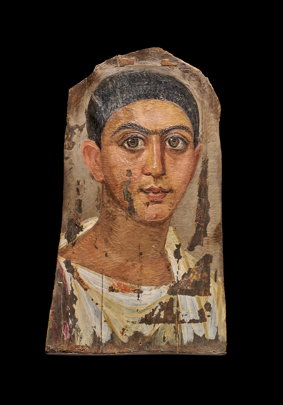An Egyptian painted wood mummy portrait of a young man