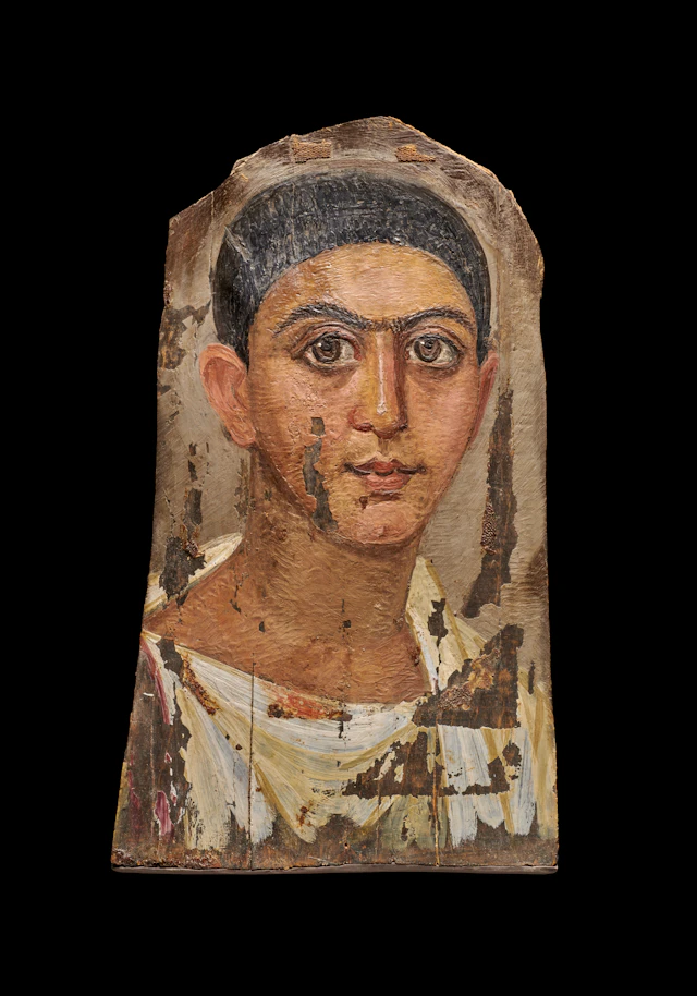 An Egyptian painted wood mummy portrait of a young man