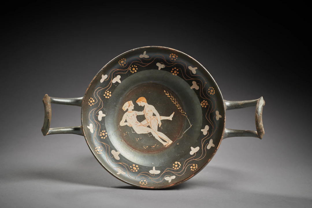A Greek Gnathia ware kylix with erotic scene