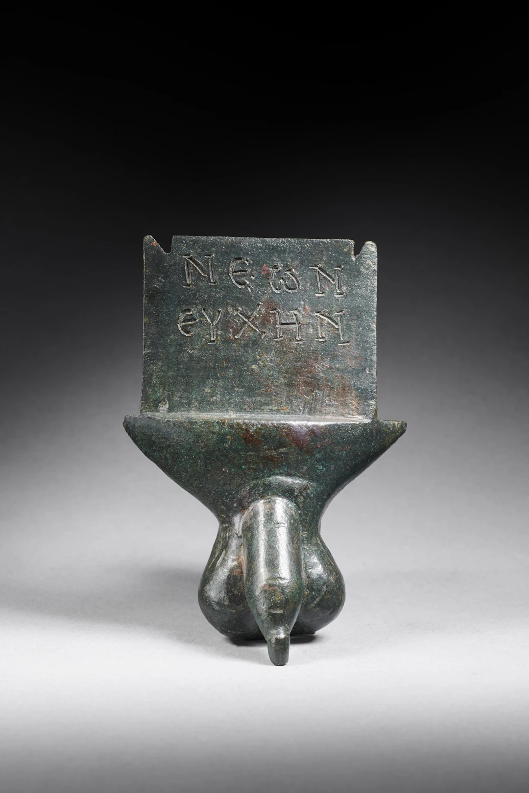A Roman bronze inscribed phallic votive plaque
