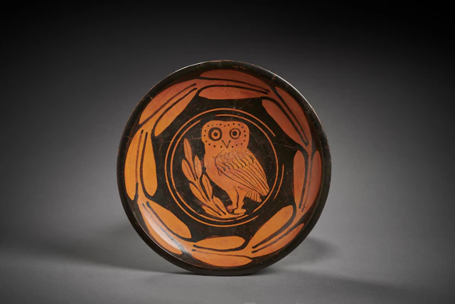 A Greek red-figured plate with an owl