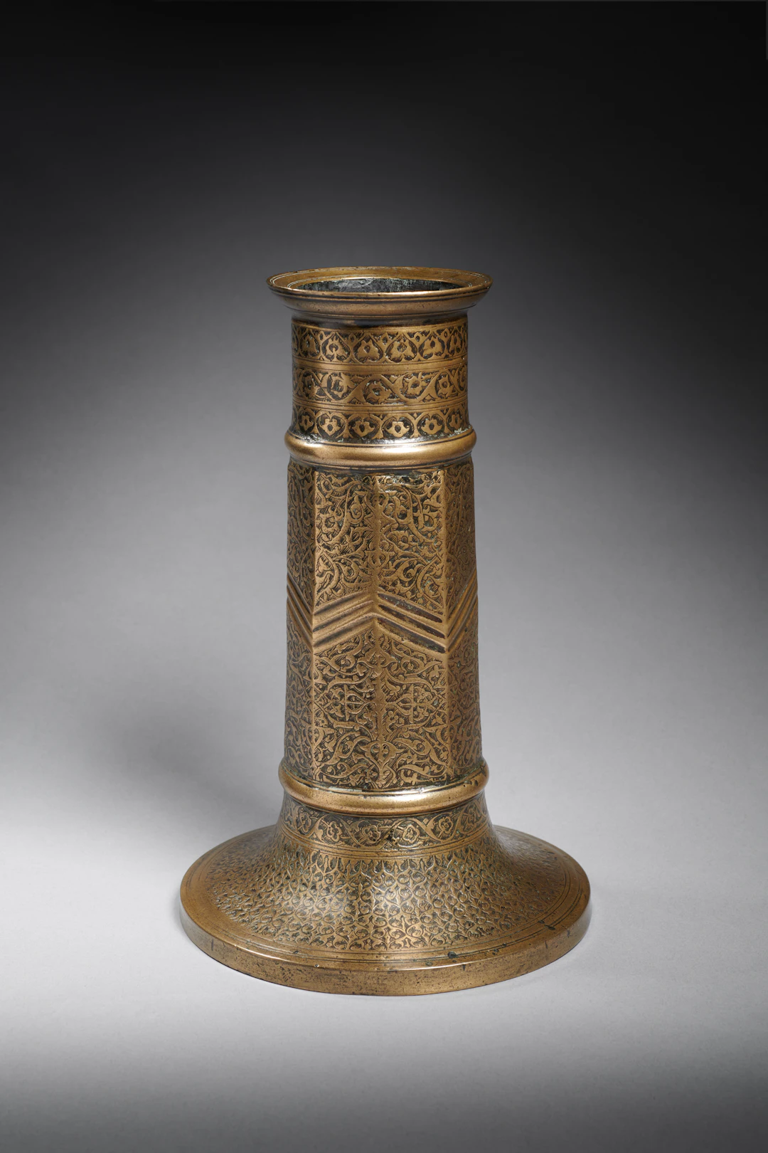 A Safavid Engraved Brass Candlestick (Sham’adan)