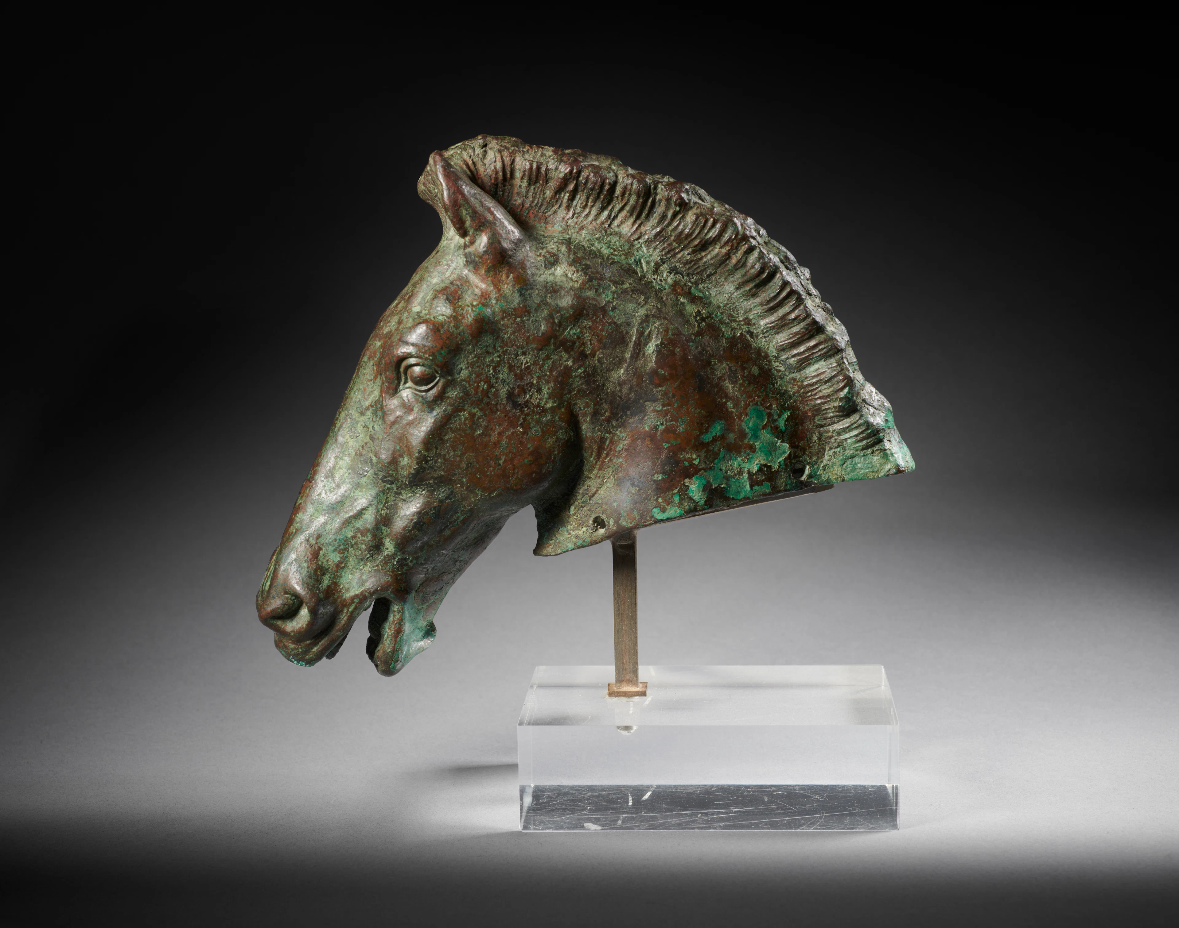 A Greek or Hellenistic bronze head of a horse