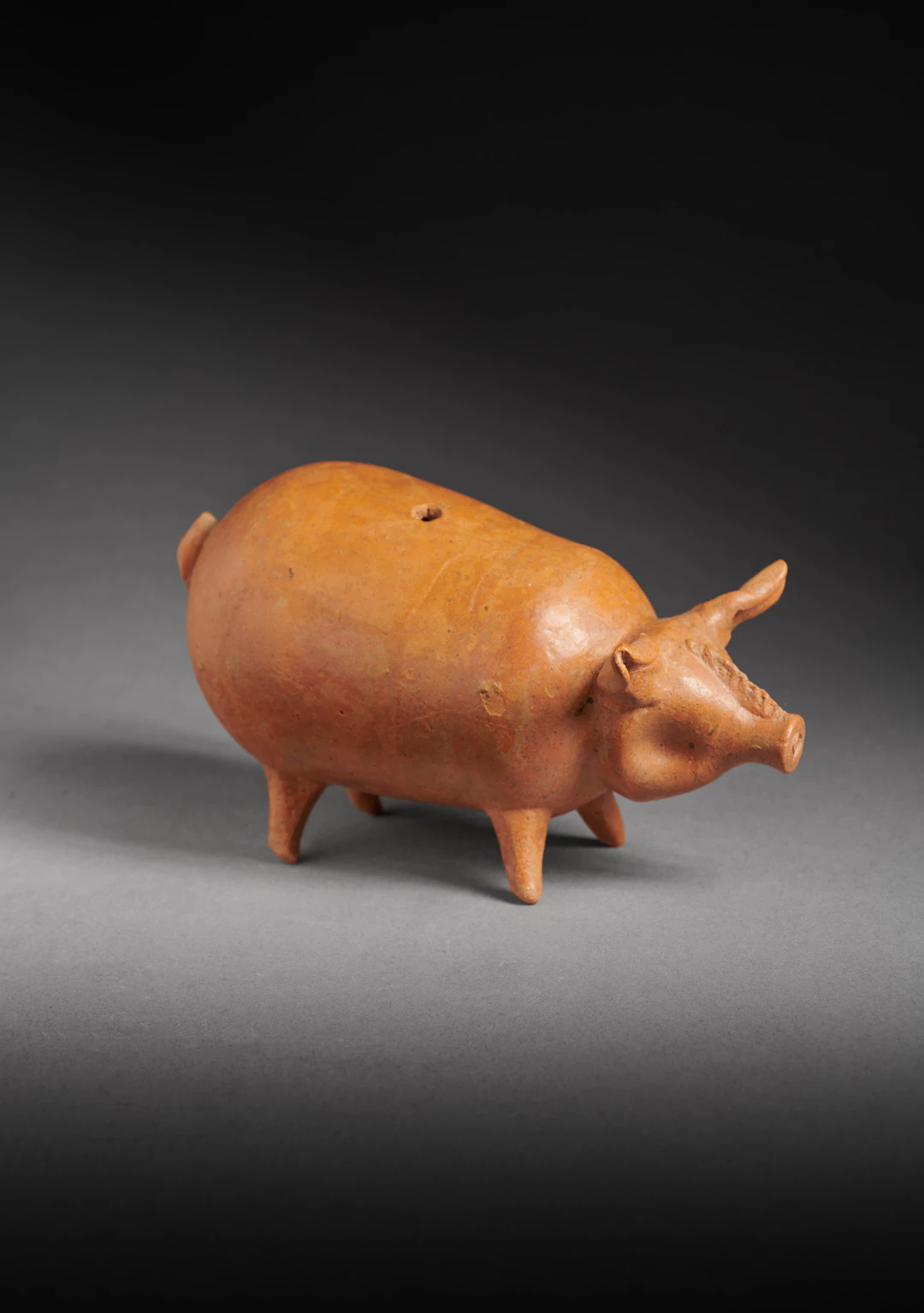 A Hellenistic pottery pig rattle