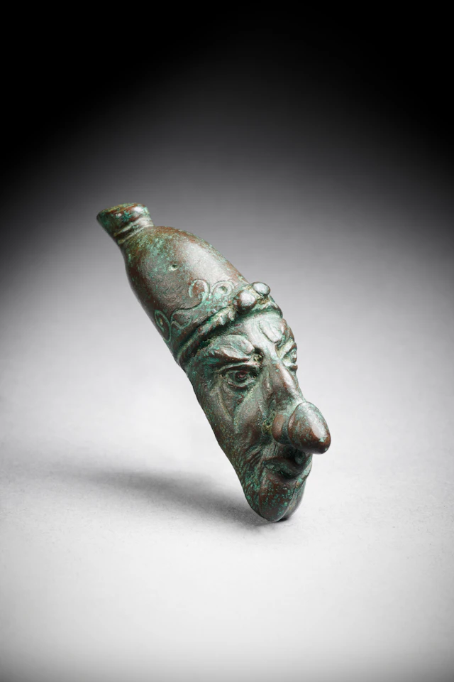 A Hellenistic bronze ithyphallic head of a grotesque