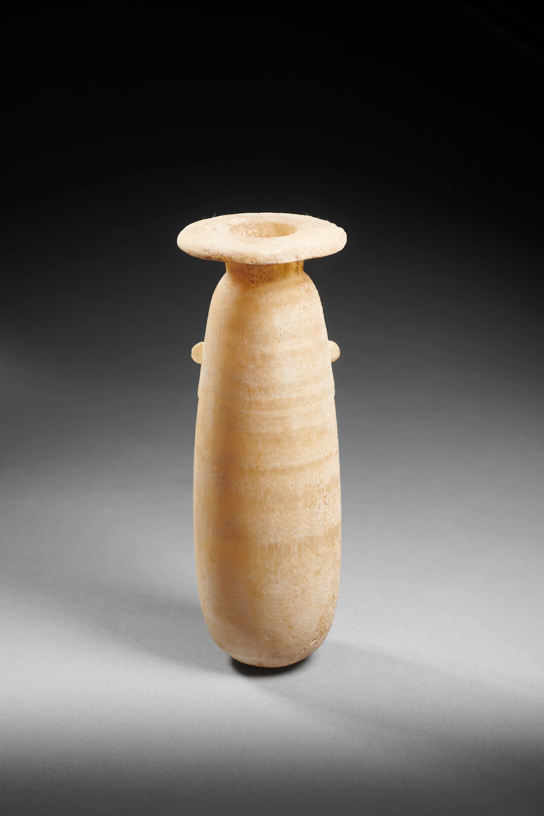 An Egyptian alabaster alabastron