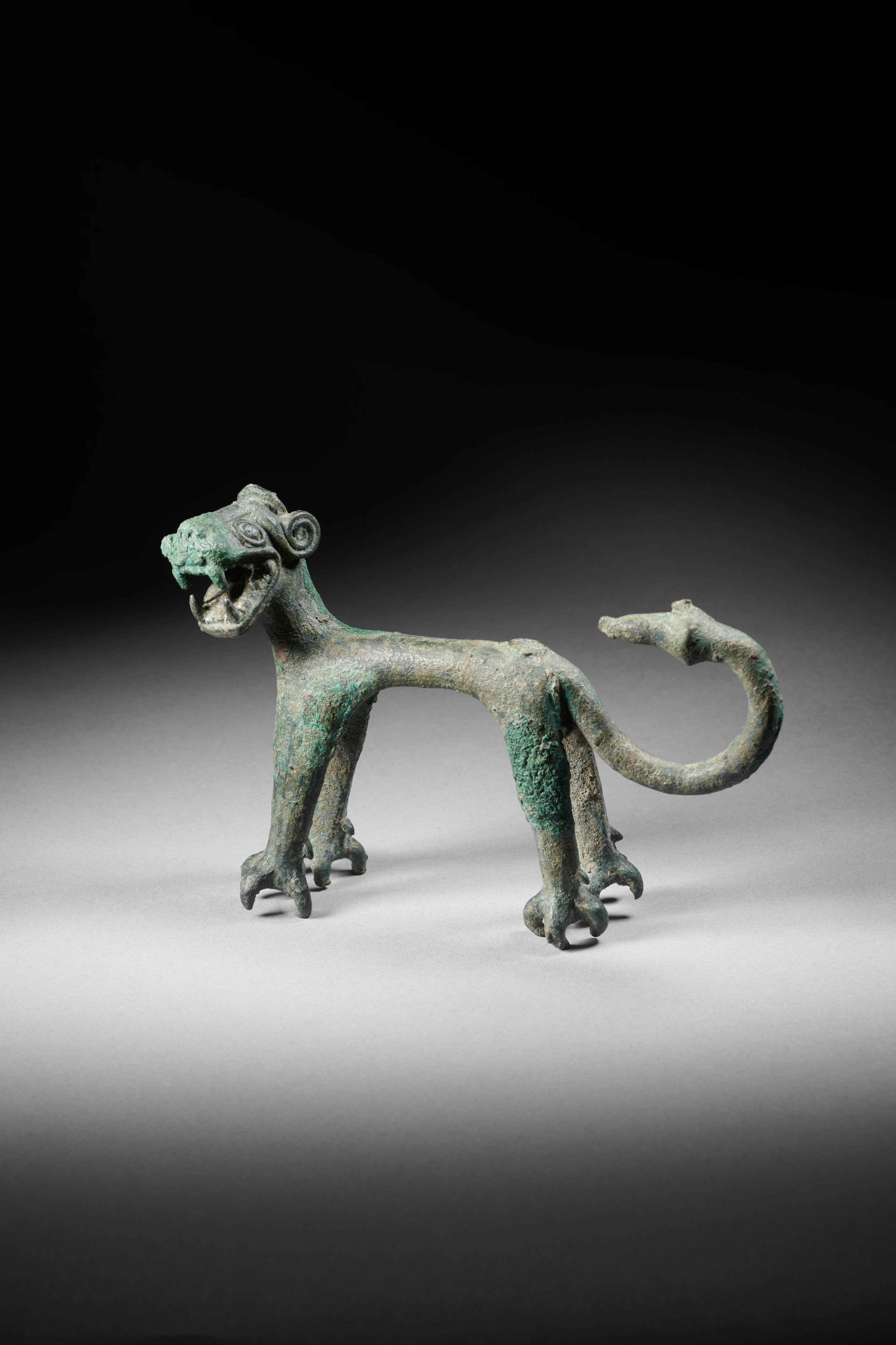 A copper alloy statuette of a lion
