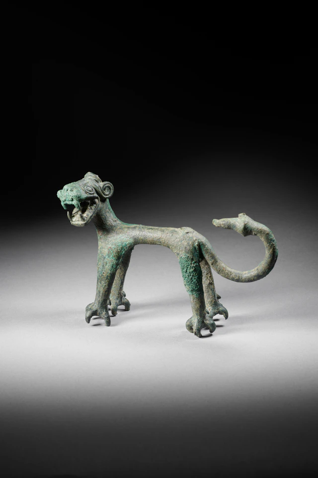 A copper alloy statuette of a lion