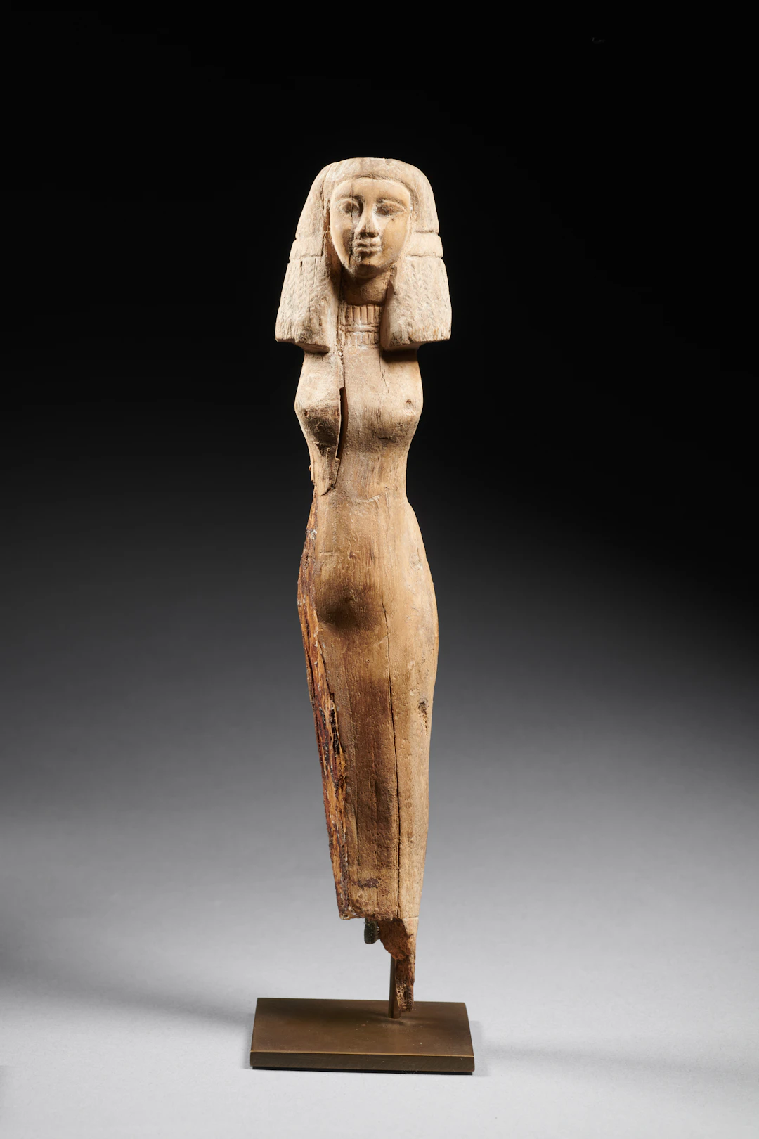 An Egyptian wood statuette of a woman
