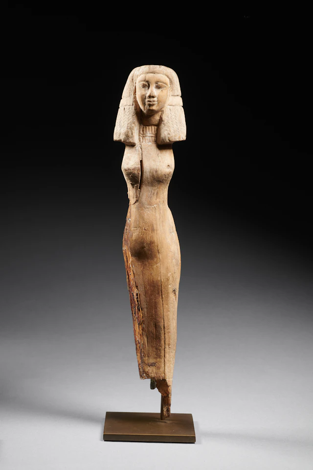 An Egyptian wood statuette of a woman