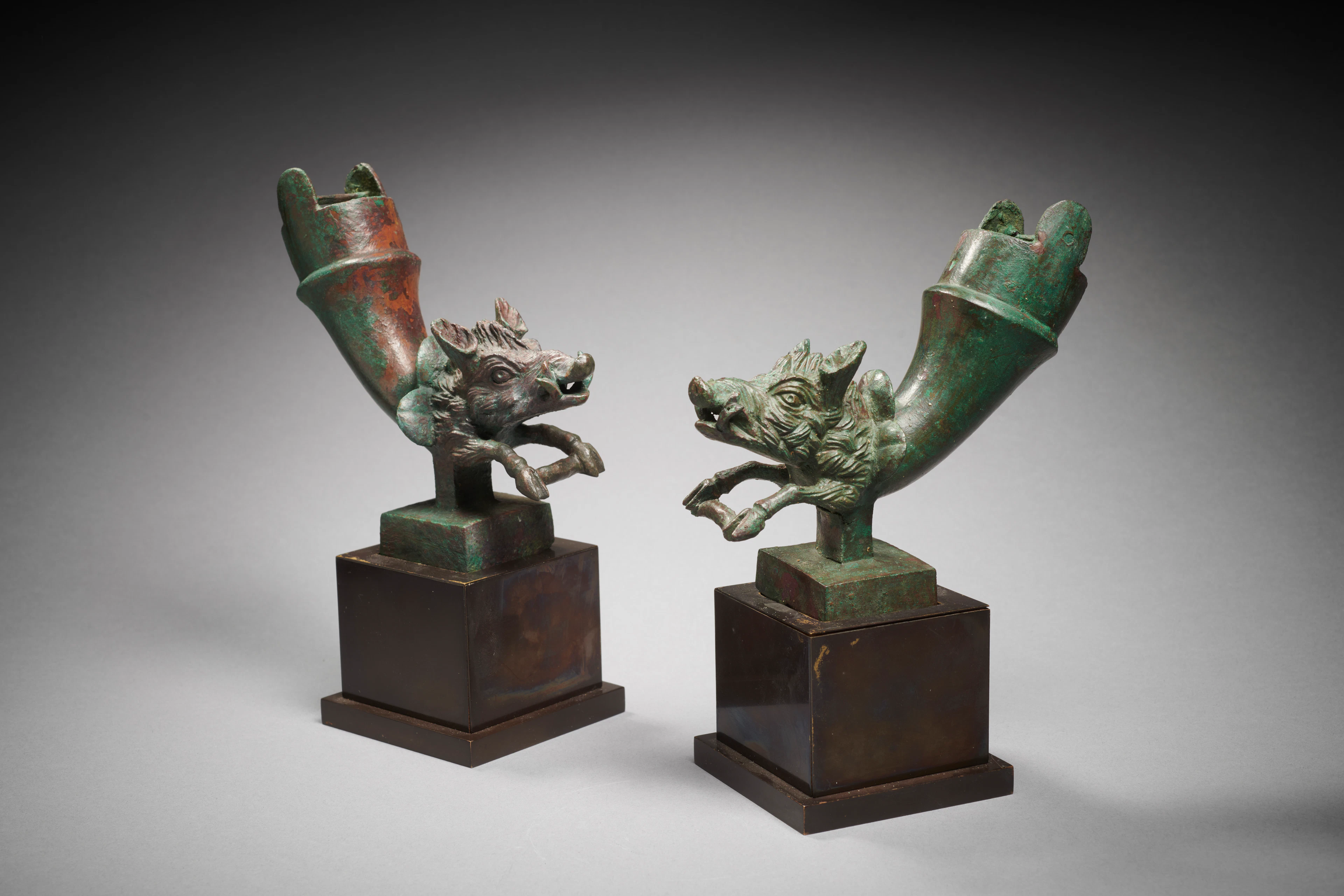 A Roman pair of bronze chariot fittings with boars