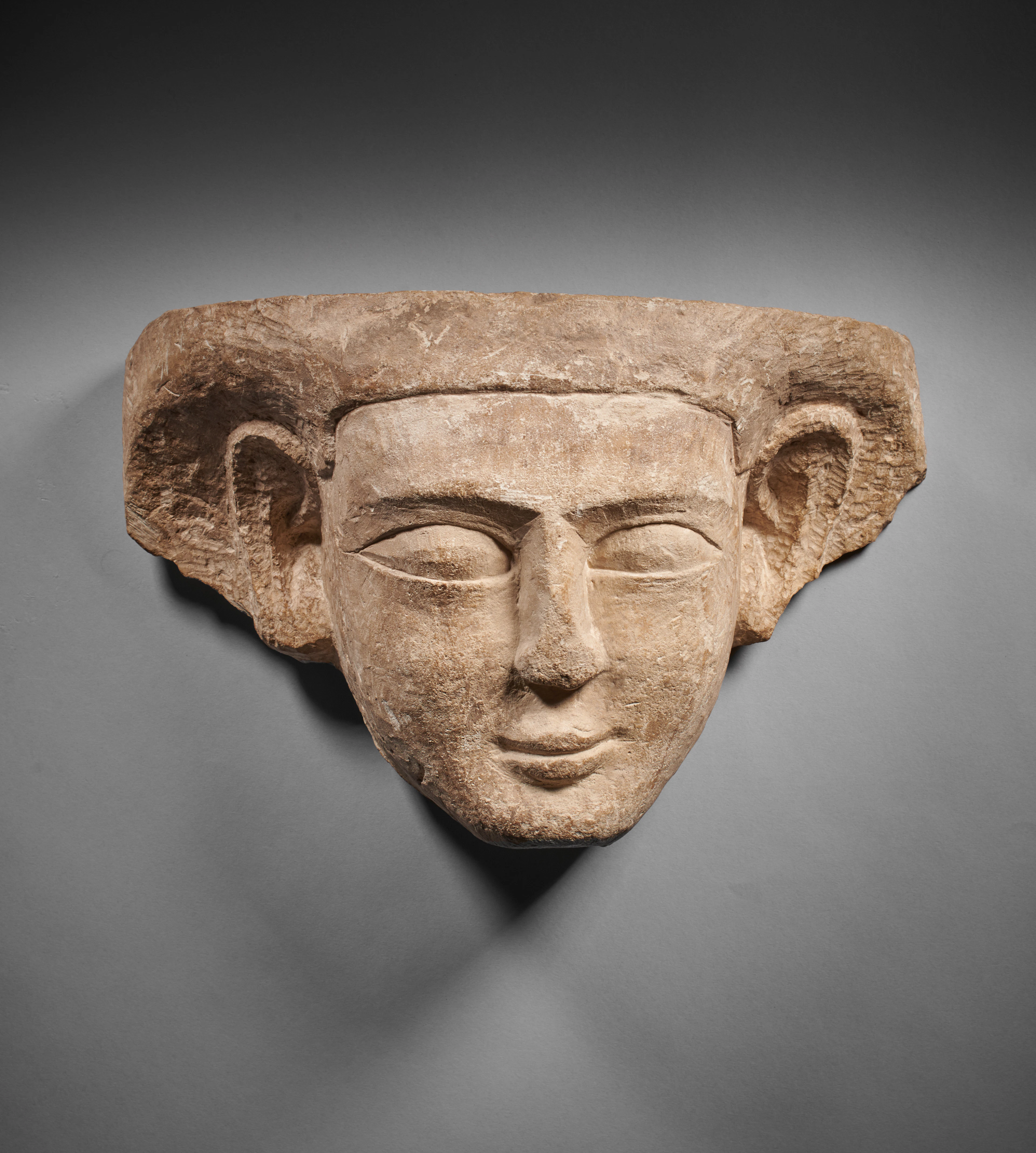 - An Egyptian limestone funerary mask
