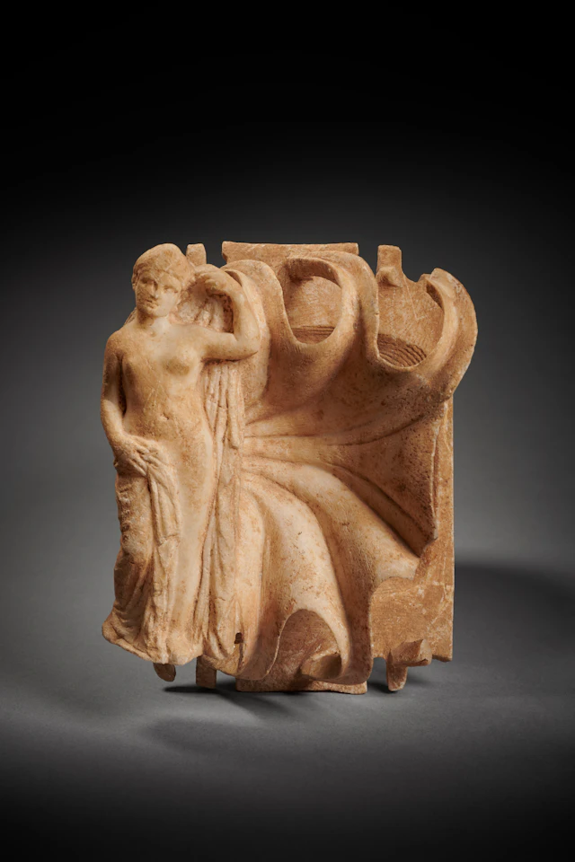 A Roman marble palette with female figure