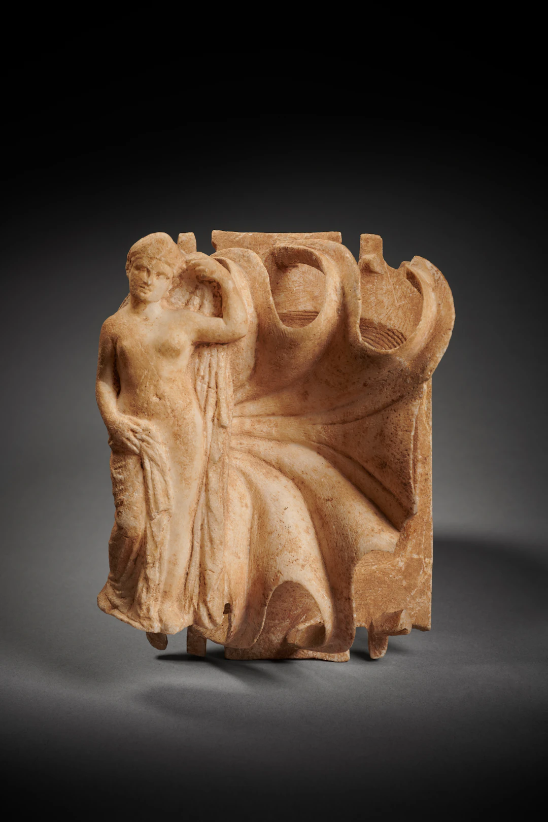A Roman marble palette with female figure