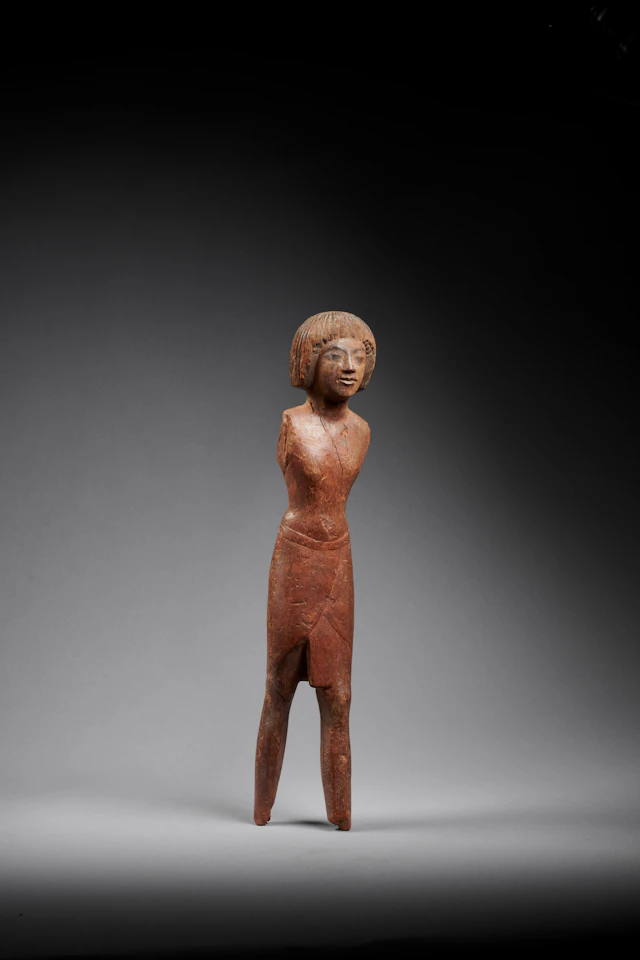 An Egyptian wood figure of a man