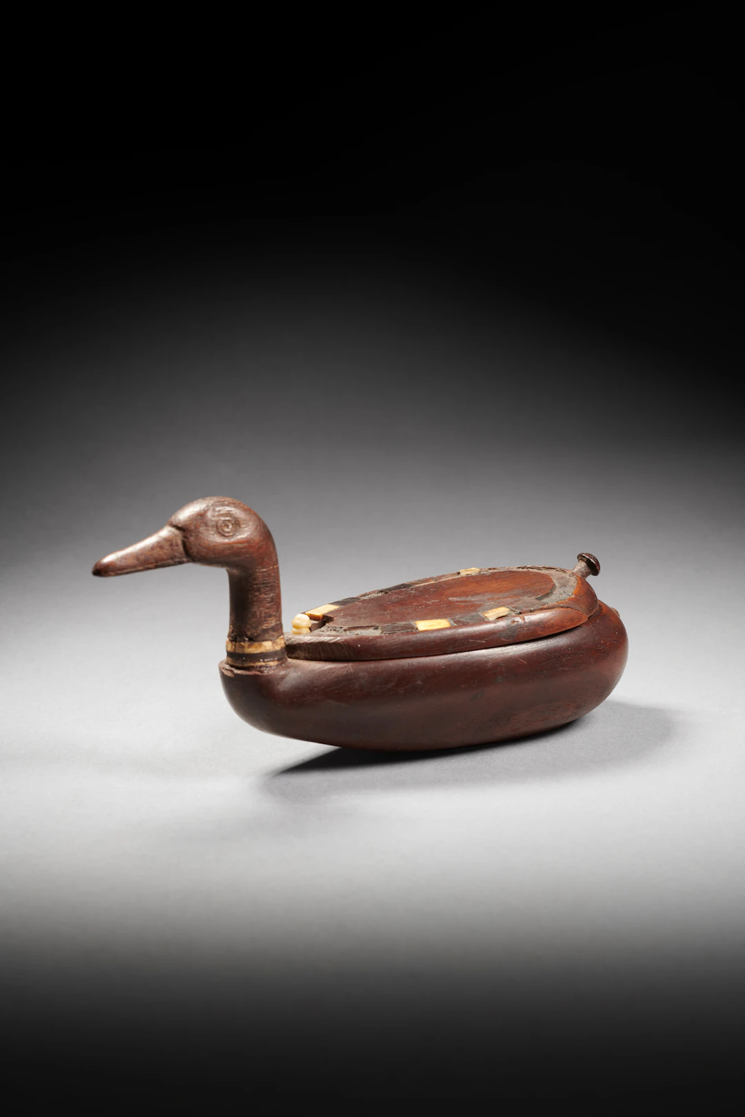 An Egyptian wood and ivory inlaid duck-shaped box