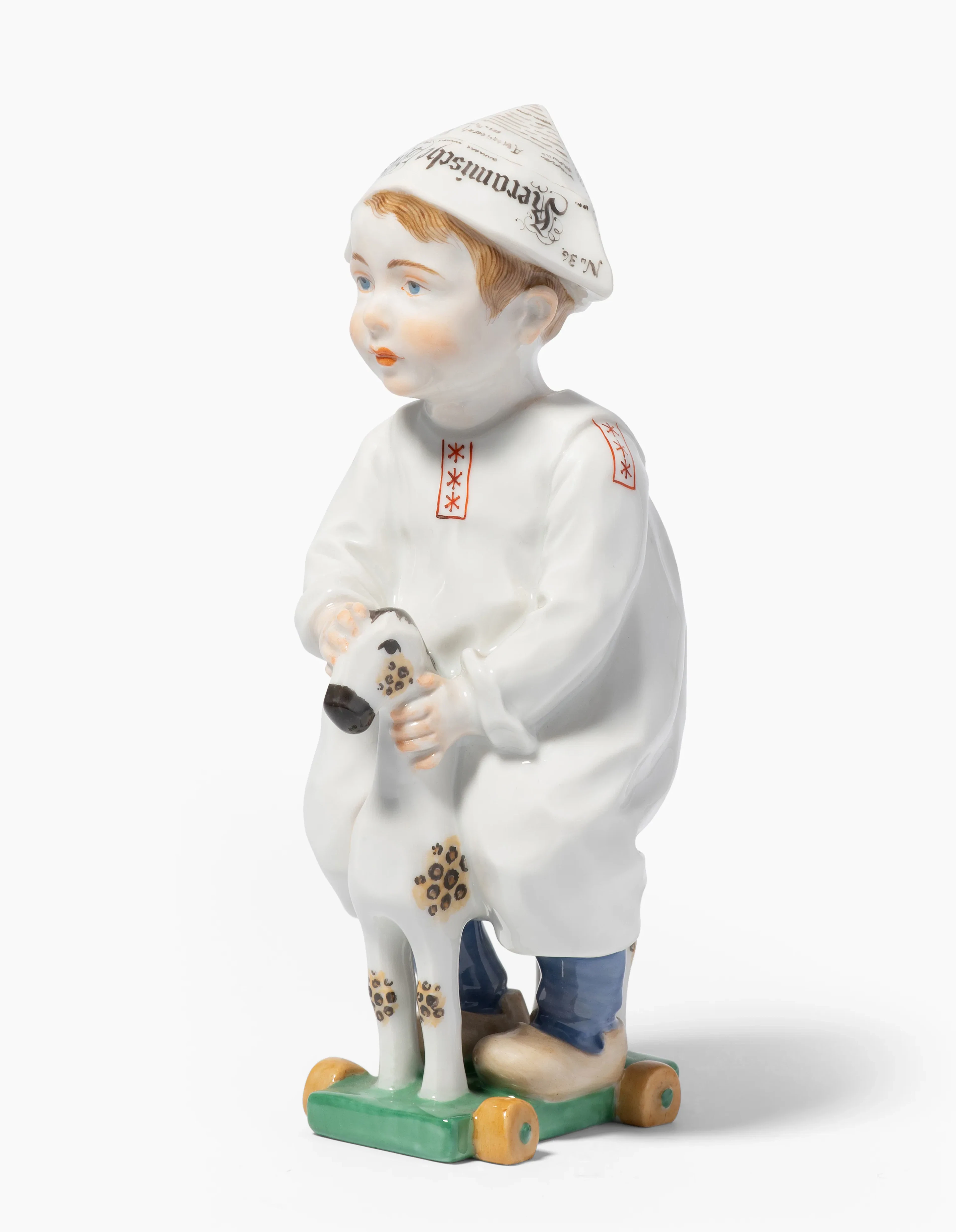 Meissen, Figur "Kind mit Zeitungsmütze, auf einem Holzpferd reitend".