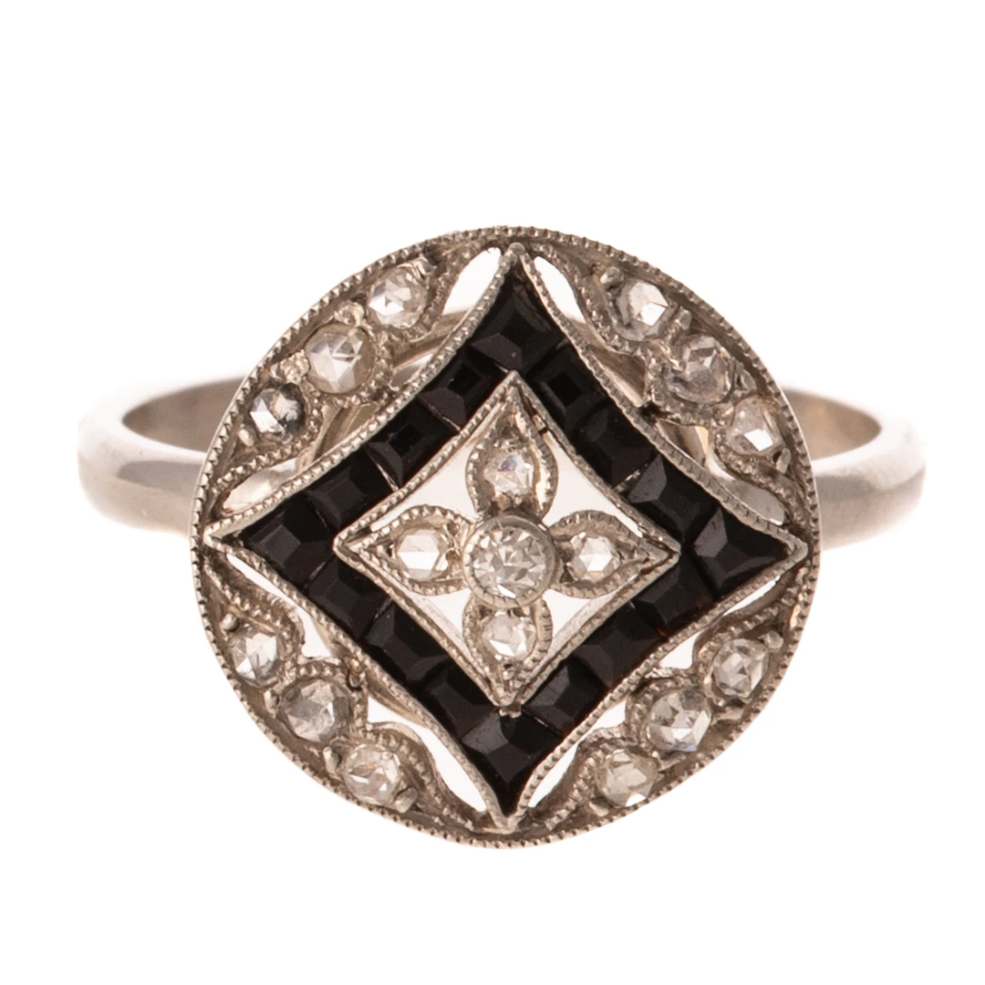 An Art Deco Diamond & Onyx Filigree Ring in Platinum