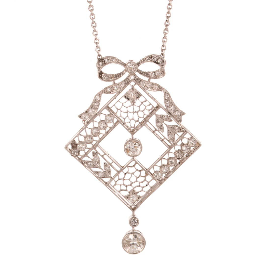 An Edwardian Diamond Filigree Bow Necklace in Platinum
