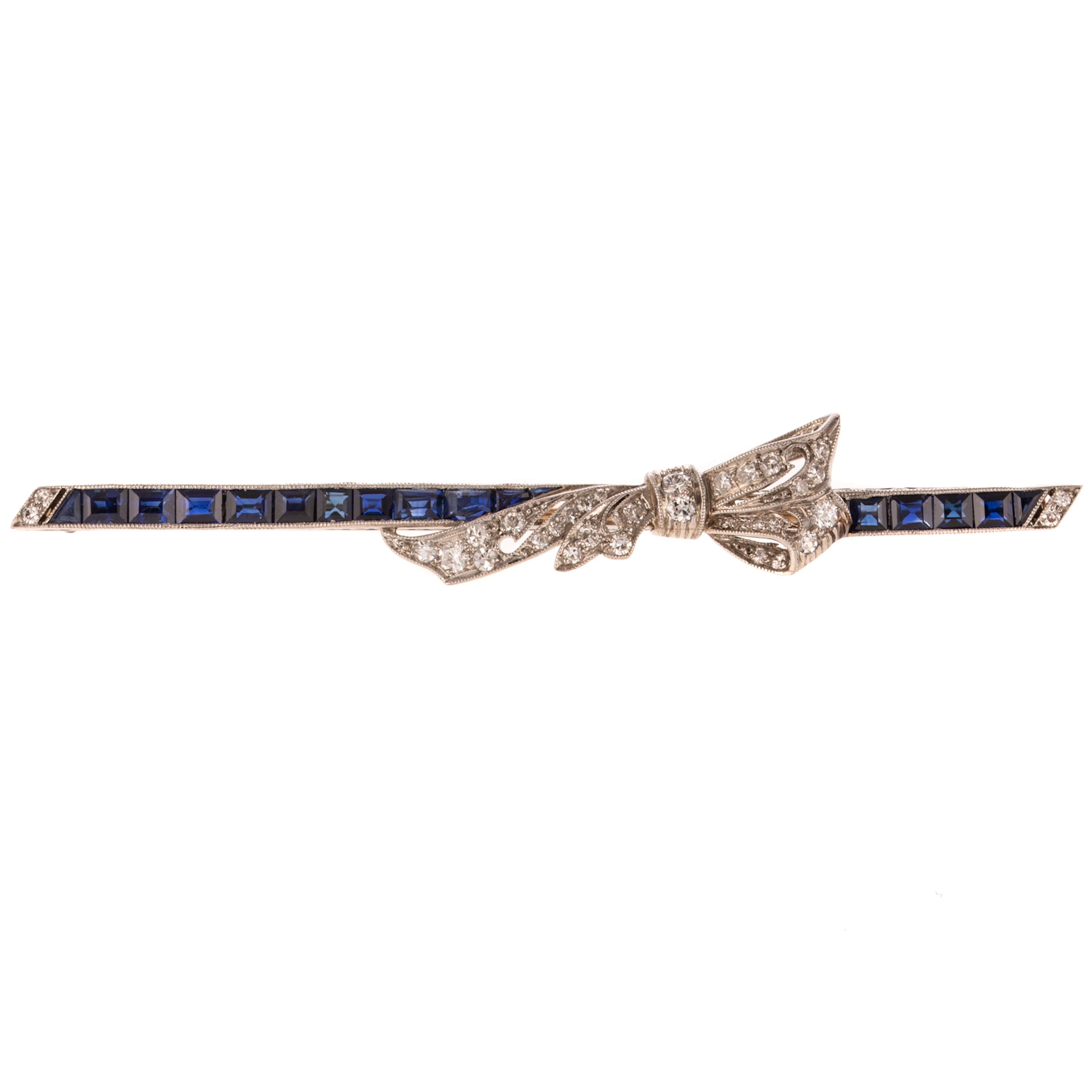 An Art Deco Sapphire & Diamond Bow Bar Pin in Platinum