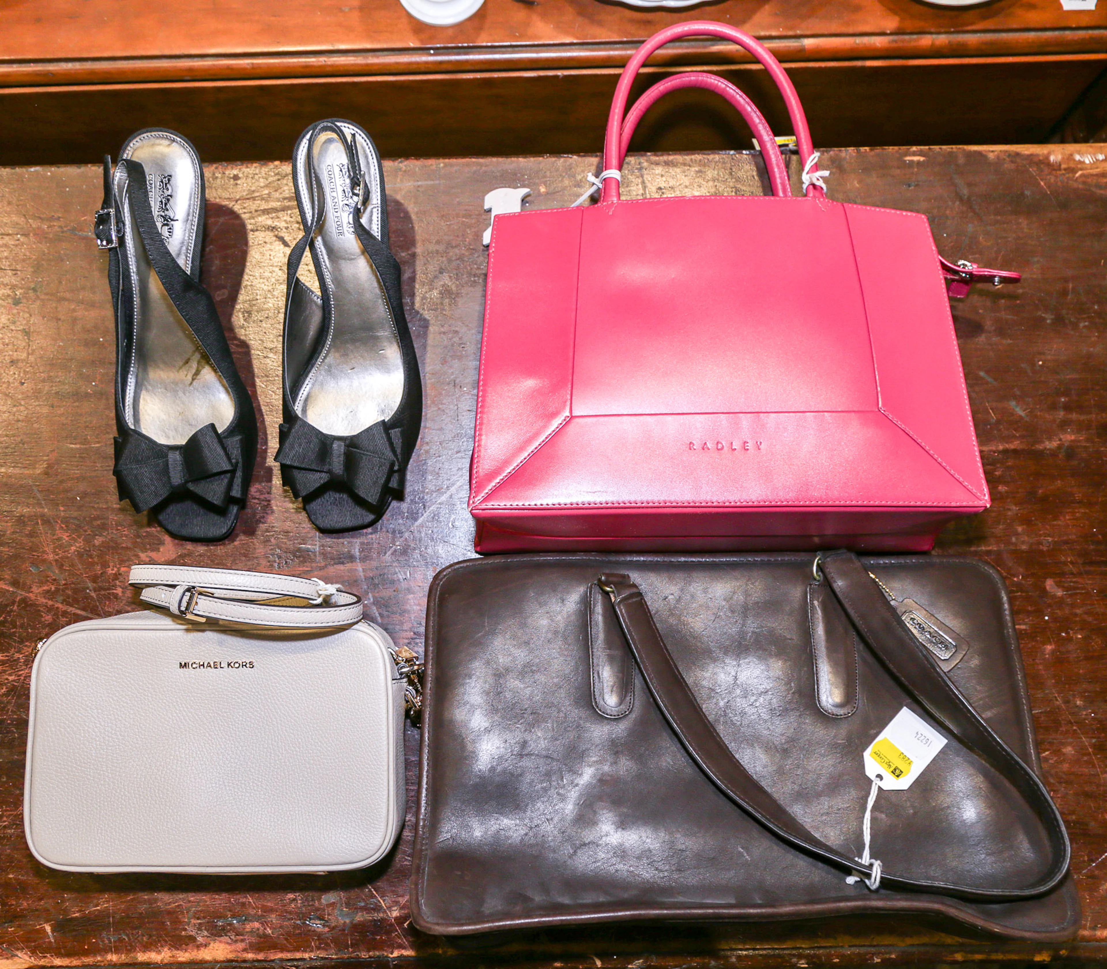 A Group of Coach, Michael Kors, & Radley Handbags