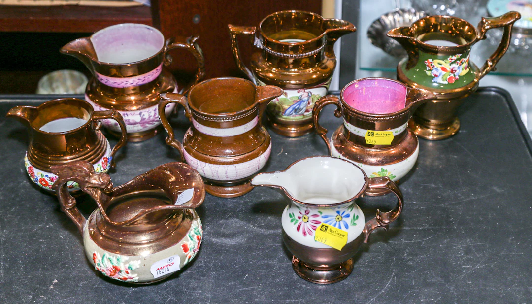 A Group of Eight Copper Lustre Cream Jugs