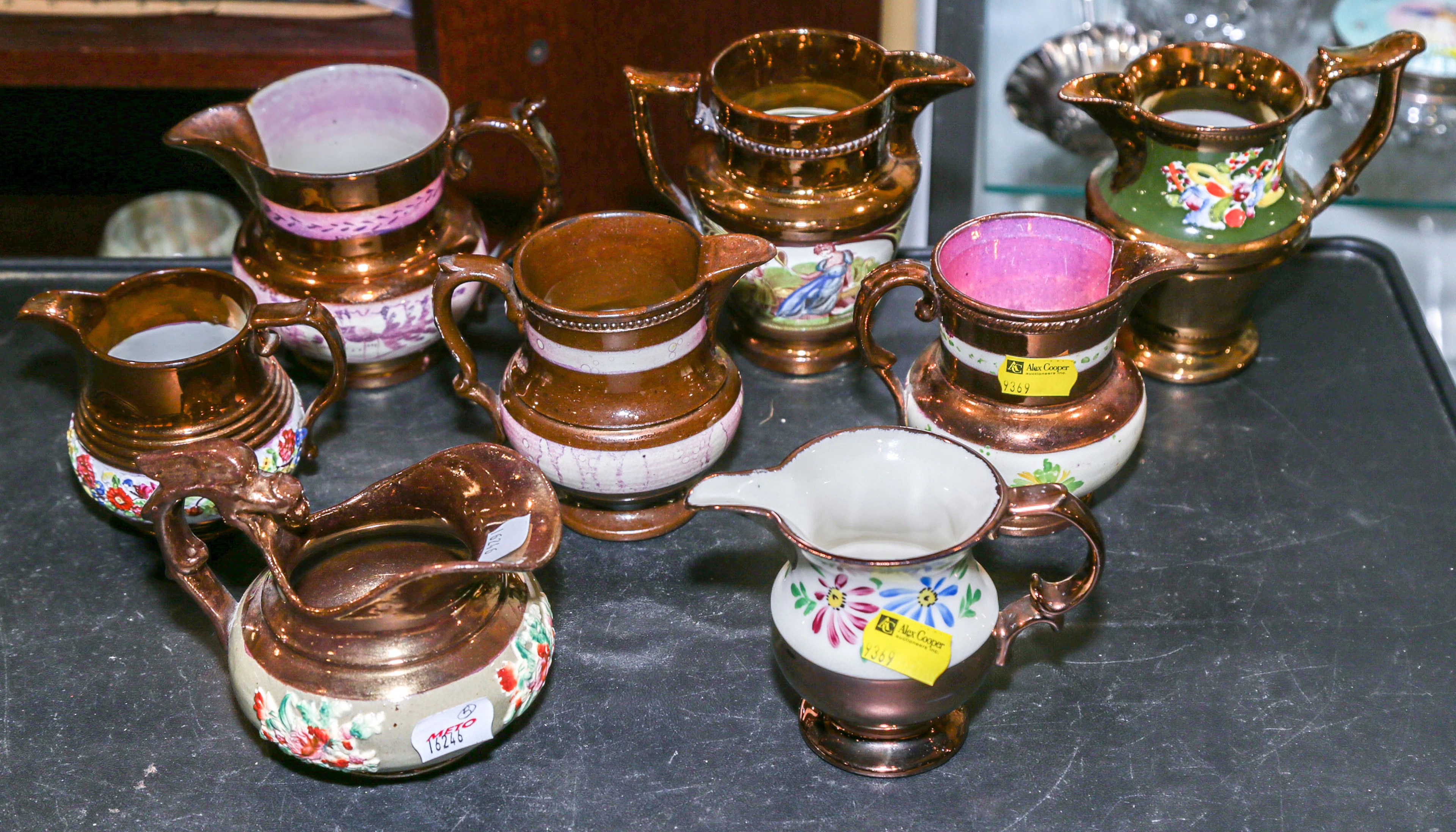 A Group of Eight Copper Lustre Cream Jugs