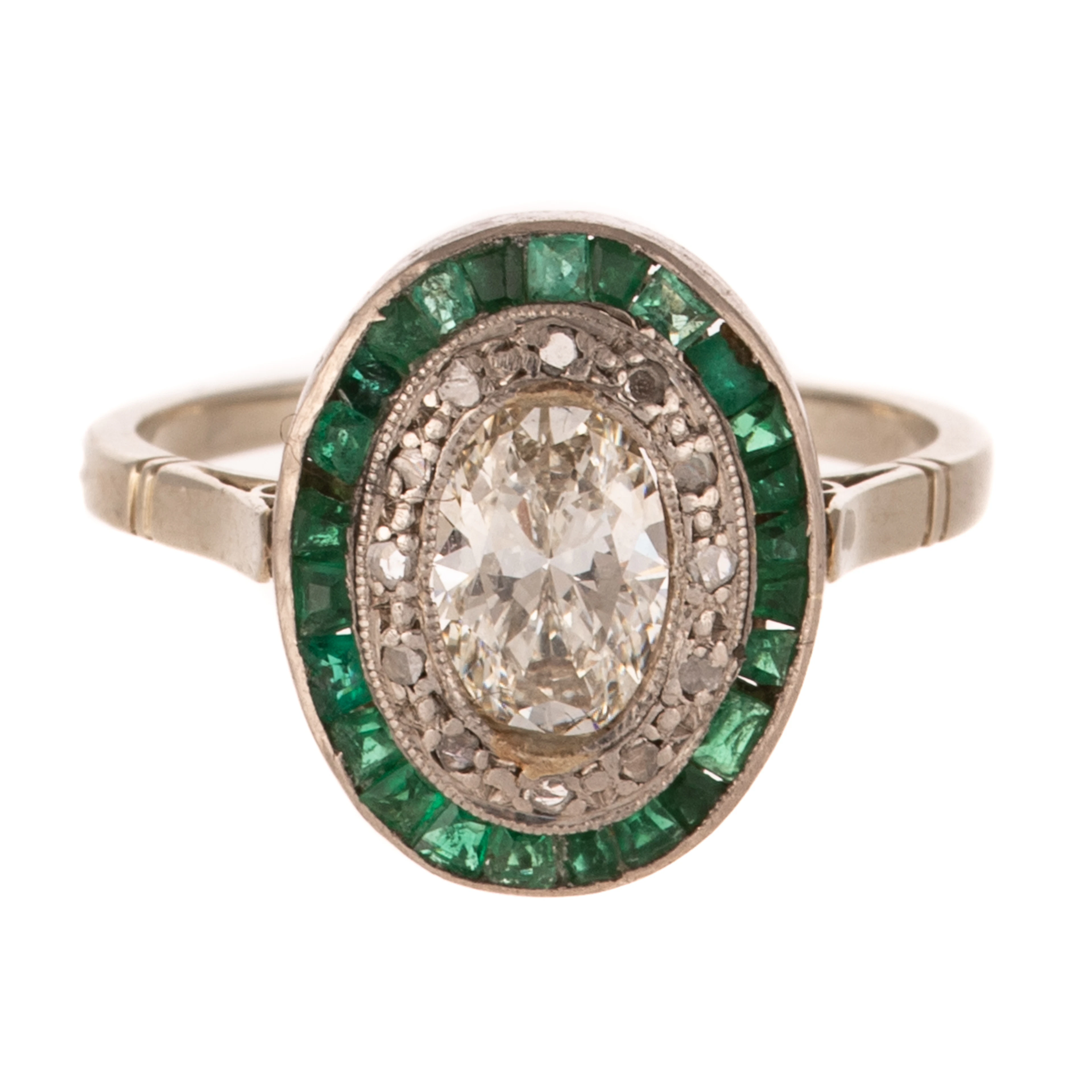 An Art Deco Diamond & Emerald Halo Ring in Platinum